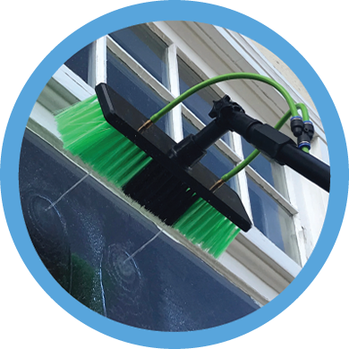 Water-fed pole extension window cleaning brush washing a large window